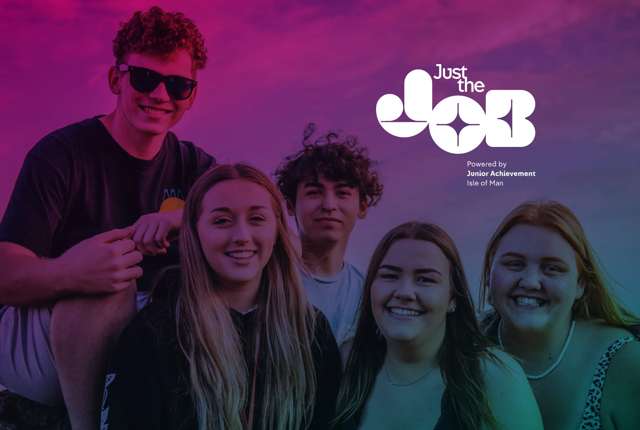 Four young people smiling outdoors under a pink and purple sky, with the Just the Job wordmark overlaid, the Isle of Man youth employment platform powered by Junior Achievement Isle of Man
